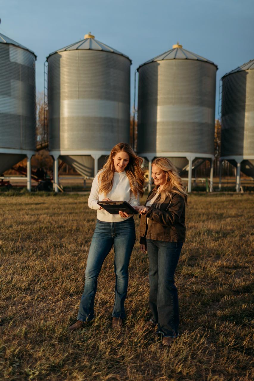Two people viewing rural land and discussing the landscape